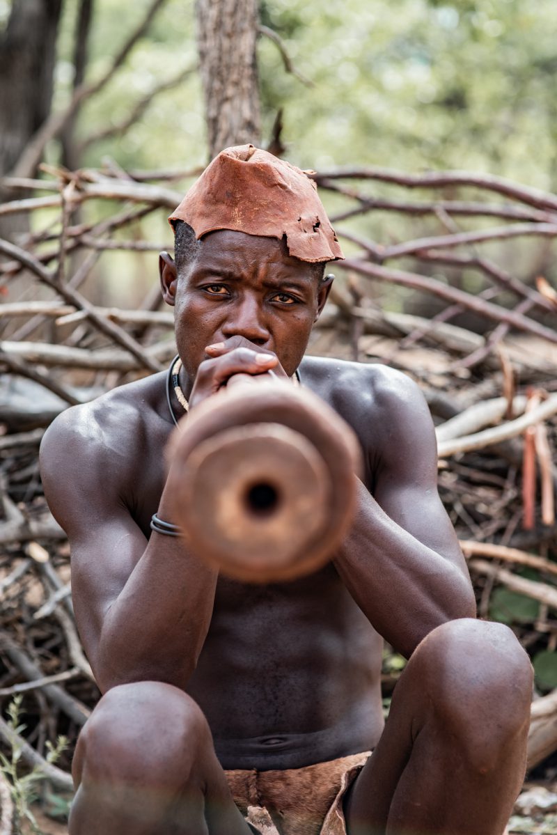 Himba man playing the 
