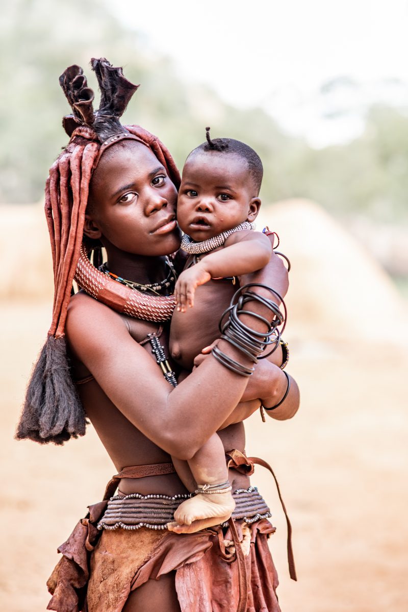 Young Himba woman and her little brother
